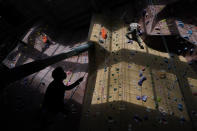 David, last name not given, bottom, belays for Frank Driscoll at Planet Granite climbing gym during the coronavirus pandemic in San Francisco, Thursday, March 4, 2021. The gym opened today to allow ten percent capacity. (AP Photo/Jeff Chiu)