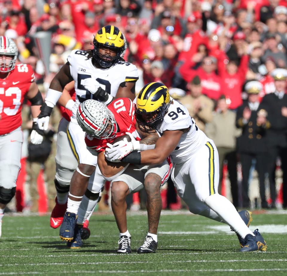 Michigan defensive lineman Kris Jenkins (94) tackles Ohio State wide receiver Xavier Johnson (10) during first half action at Ohio Stadium in Columbus Saturday, November 26, 2022.