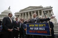 U.S. Senate Majority Leader Harry Reid (D-NV) gathers with other Democratic Party senate members and Washington D.C. Mayor Vincent Gray (L) on the steps of the U.S. Capitol in Washington, October 9, 2013. Reid called on Republican members of congress to negotiate an end to the U.S. Government shutdown entering its ninth day. REUTERS/Jason Reed