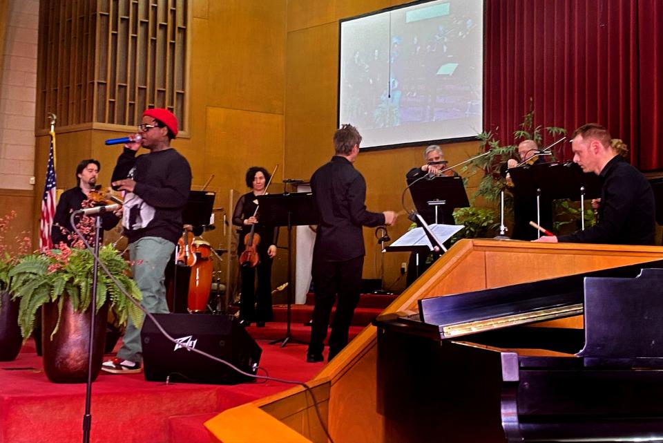 Rapper, activist and entrepreneur Jabee Williams performs a musical selection with the Oklahoma City Philharmonic, under the direction of Maestro Alexander Mickelthwate, at Fifth Street Baptist Church, 801 NE 5, during a visit to the house of worship which was the home church of the late civil rights leader Clara Luper. 
(Photo: Provided)