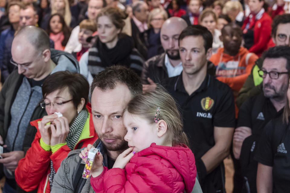 People observe a minute of silence near a memorial during a one-year anniversary service at Zaventem Airport in Brussels on Wednesday, March 22, 2017. The suicide bombings at the Brussels airport and subway on March 22, 2016, killed 32 people and wounded more than 300 others. (AP Photo/Geert Vanden Wijngaert)