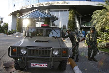 Thai soldiers stand in front of the National Broadcasting Services of Thailand television station in Bangkok May 20, 2014. REUTERS/Athit Perawongmetha