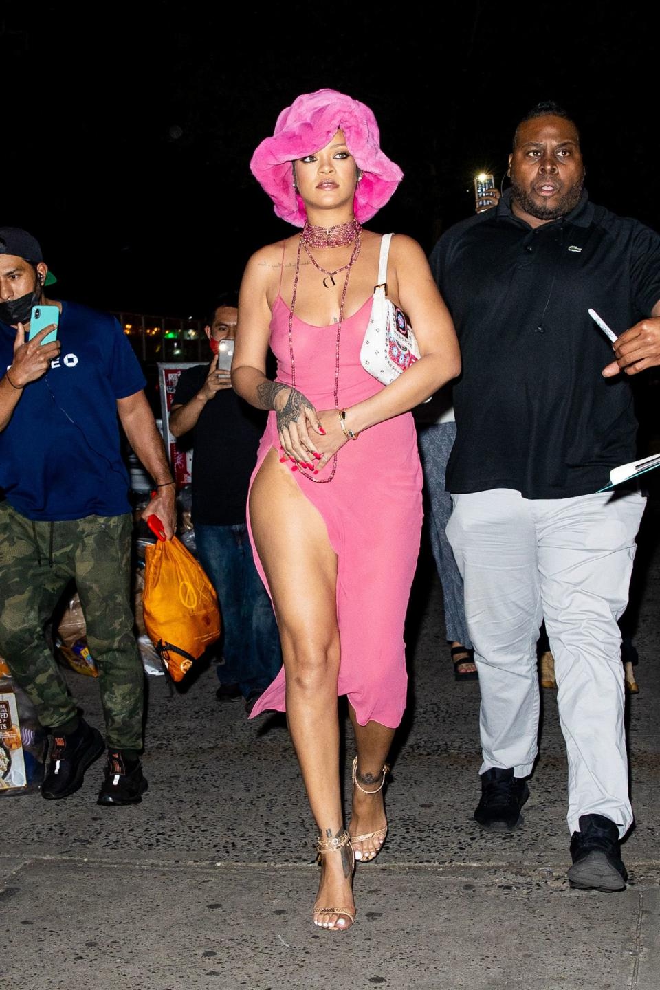 Rihanna in a pink fur hat and pink dress