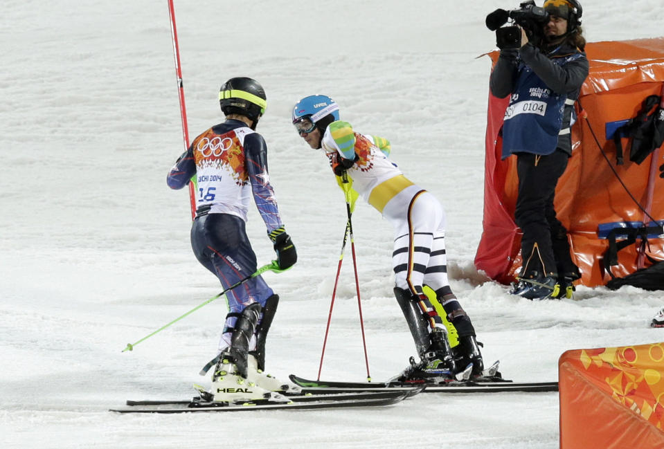 United States' Ted Ligety, left, and Germany's Felix Neureuther talk after they both skied out of the second run of the men's slalom at the Sochi 2014 Winter Olympics, Saturday, Feb. 22, 2014, in Krasnaya Polyana, Russia. (AP Photo/Gero Breloer)