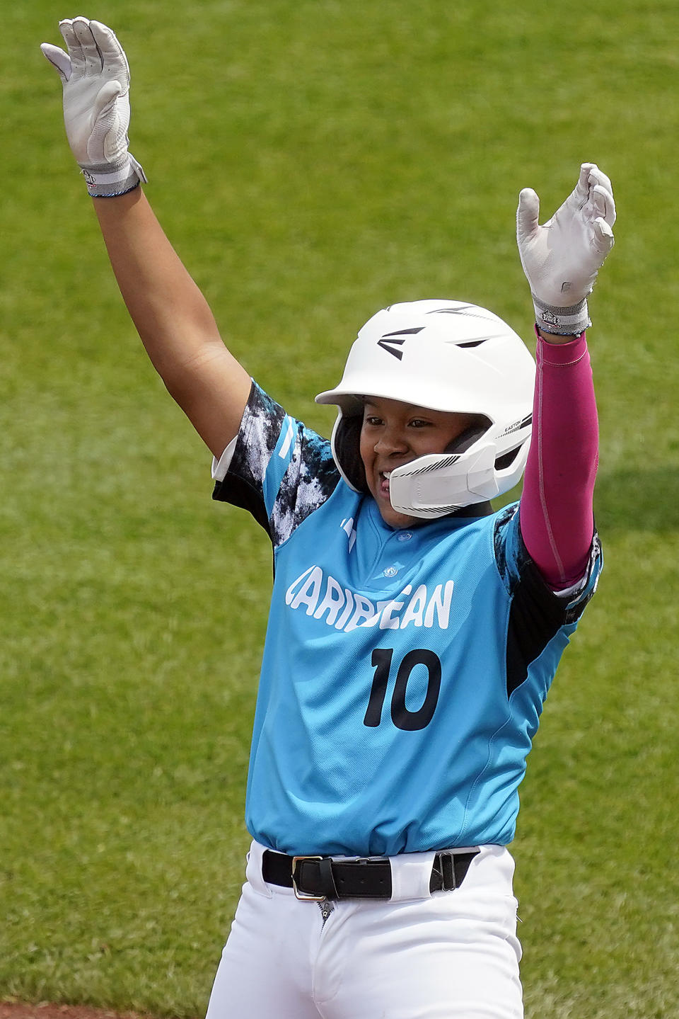 Curacao's Jay-Dlynn Wiel (10) celebrates standing on first base after getting a base hit off of Venezuela starting pitcher Adrian Soto during the first inning of a baseball game at the Little League World Series tournament in South Williamsport, Pa., Monday, Aug. 21, 2023. (AP Photo/Tom E. Puskar)