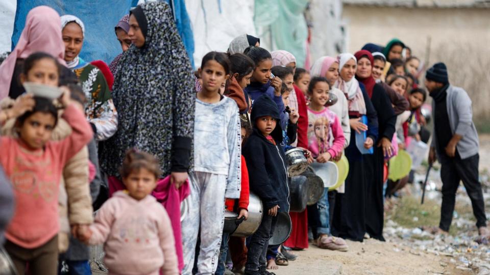 PHOTO: Palestinians stand in a line as they wait to receive food amid shortages of food supplies, Jan. 17, 2024, in Rafah in the southern Gaza Strip. (Mohammed Salem/Reuters)