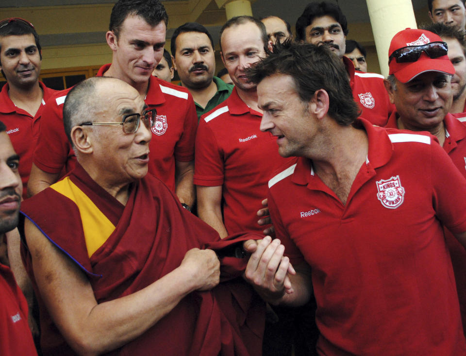 Tibet's exiled Buddhist spiritual leader the Dalai Lama speaks with Adam Gilchrist (R), captain of Indian Premier League (IPL) Kings XI Punjab cricket team, at Dalai Lama's residence on the outskirts of the northern Indian hill town of Dharamsala May 18, 2011. Kings XI Punjab team met Dalai Lama on Wednesday ahead of their IPL cricket match against Deccan Chargers on May 21. REUTERS/Stringer (INDIA - Tags: SPORT CRICKET PROFILE RELIGION)
