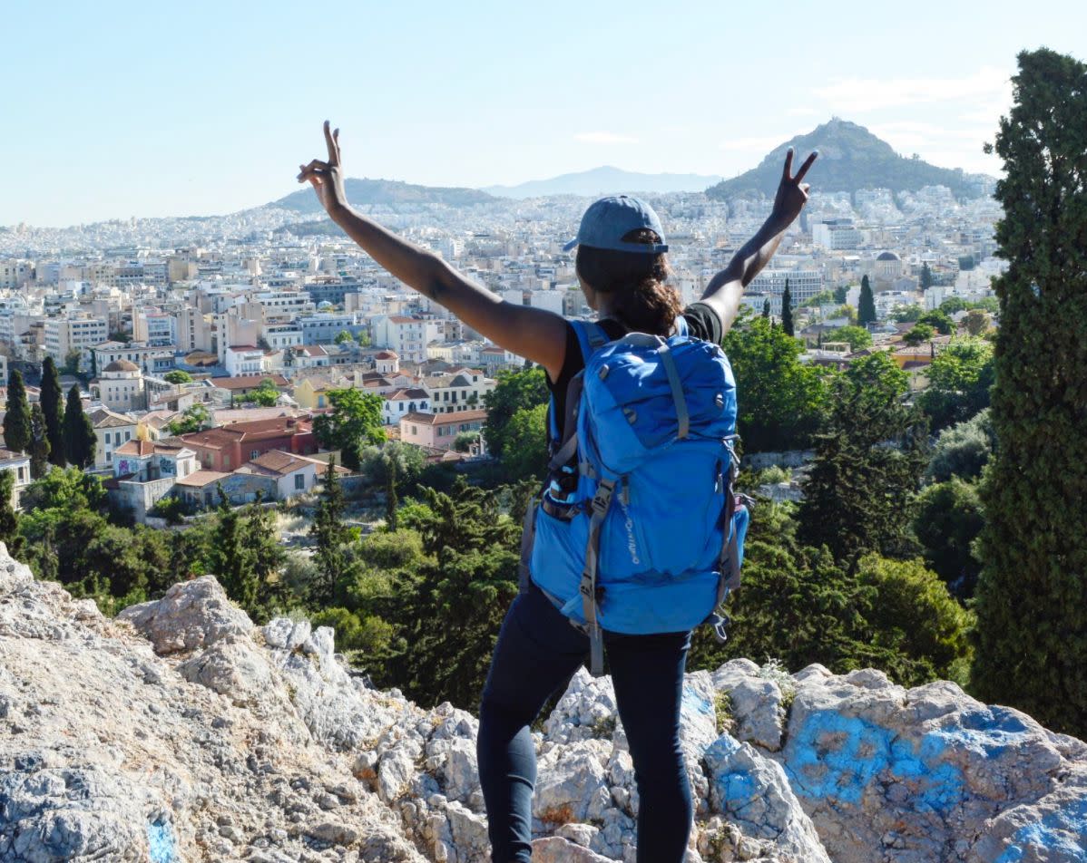 The author in 2017 overlooking Athens, Greece, during the three weeks I traveled carrying only my blue backpack. (Photo: Photo Courtesy of Diane Wesh)