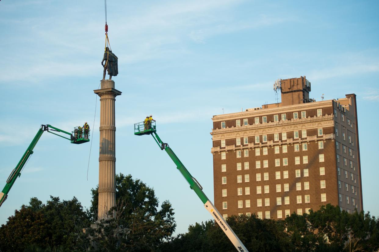 Workers use cherry pickers to access the statue of John C. Calhoun atop the monument in his honor at Marion Square on June 24, 2020 in Charleston, South Carolina. Former Vice President Calhoun is well-known for defending slavery.