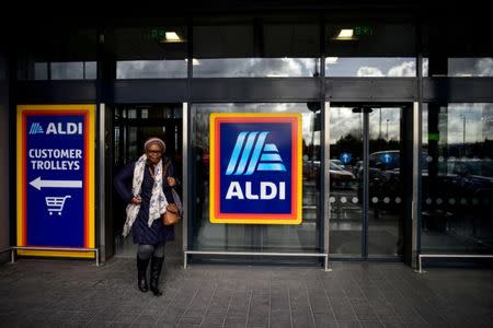 FILE PHOTO: A shopper leaves an Aldi store in London, Britain February 15, 2018. REUTERS/Peter Summers/File Photo