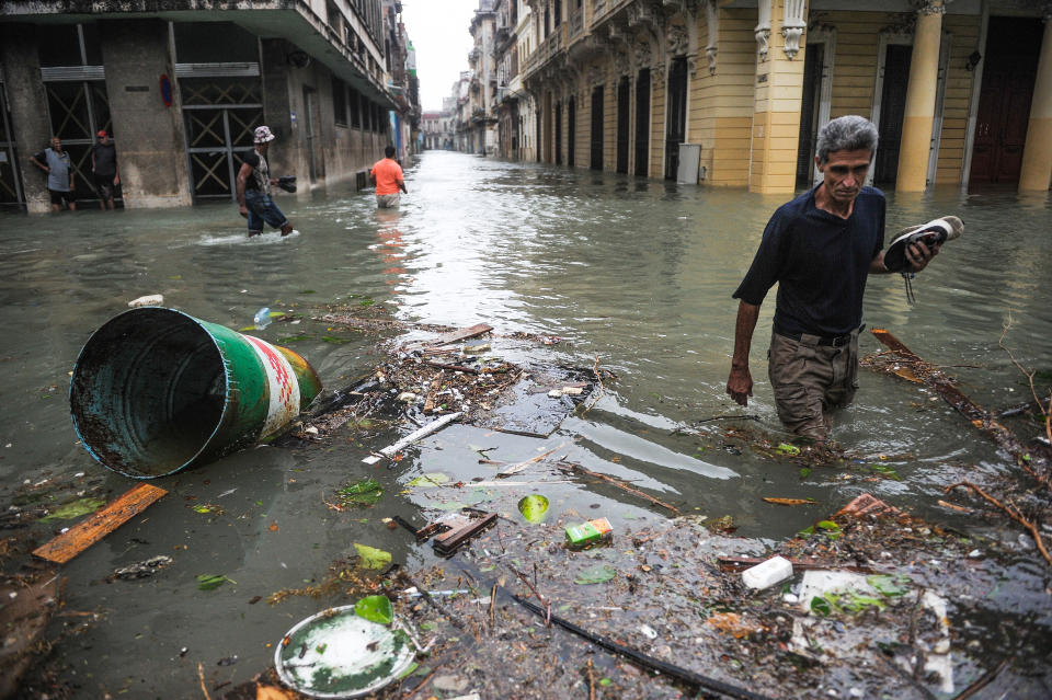 <p>Cubans wade through flooded streets in Havana, on Sept. 10, 2017. (Photo: Yamil Lage/AFP/Getty Images) </p>