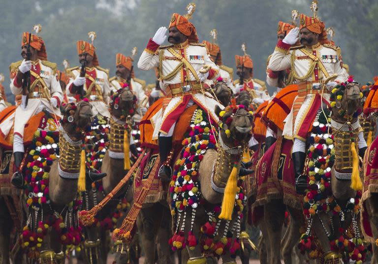 Indian military personnel salute while riding camels during the nation's Republic Day Parade in New Delhi on January 26, 2015