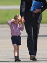 <p>George said goodbye to Germany in a checked shirt and navy tailored shorts. [Photo: PA] </p>