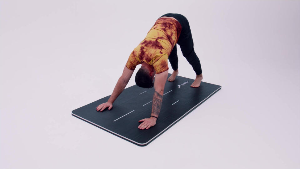 A Pliability athlete demonstrating the down dog pose