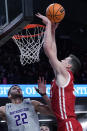 Wisconsin center Chris Vogt, right, dunks against Northwestern forward Pete Nance during the first half of an NCAA college basketball game in Evanston, Ill., Tuesday, Jan. 18, 2022. (AP Photo/Nam Y. Huh)