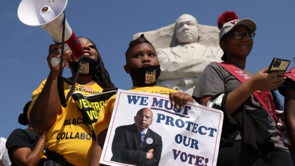 Shenita Binns (L) and her daughter Ysrael Binns (2nd L) of Atlanta, Georgia, participate in a “Freedom Friday March” protest at Martin Luther King, Jr. Memorial August 6, 2021 in Washington, DC. (Photo by Alex Wong/Getty Images)
