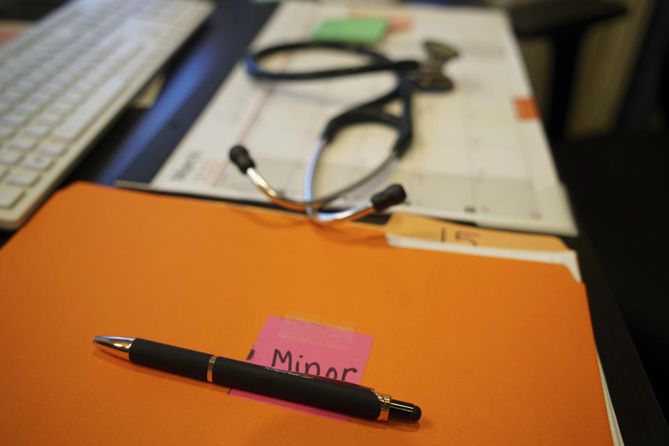 A file folder with the label "minor" sits on the desk of Dr. Leah Torres at the West Alabama Women's Center in Tuscaloosa, Ala., on Monday, March 14, 2022. The clinic is run by Robin Marty, author of a 247-page manual titled "The Handbook for a Post-Roe America." (AP Photo/Allen G. Breed)