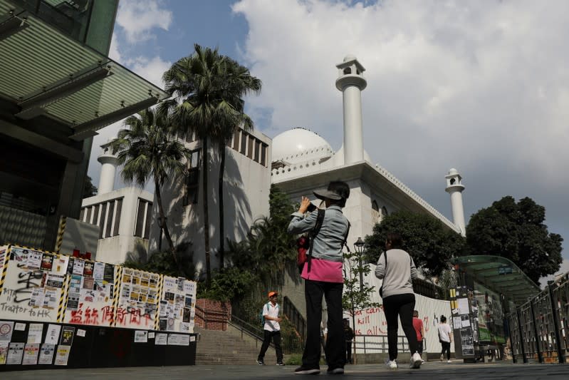 People go about their day outside Kowloon Masjid and Islamic Centre in Hong Kong’s tourism district Tsim Sha Tsui