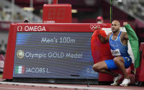 Lamont Marcell Jacobs, of Italy celebrates after winning the gold medal in the final of the men's 100-meters at the 2020 Summer Olympics, Sunday, Aug. 1, 2021, in Tokyo, Japan. (AP Photo/Martin Meissner)