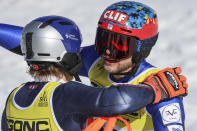 Greece's Aj Ginnis, right, hugs Norway's Henrik Kristoffersen after completing the men's World Championship slalom, in Courchevel, France, Sunday Feb. 19, 2023. Ginnis won the silver as Kristoffersen took the gold. (AP Photo/Marco Trovati)