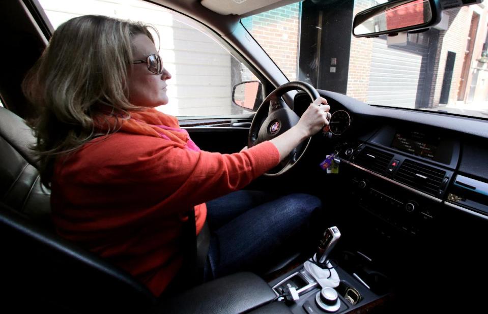 In this Tuesday, March 11, 2014 photo, Boston Marathon bombing survivor Roseann Sdoia drives back to her apartment in the North End neighborhood of Boston, following a therapy and training session. At home, she must climb the almost 20 stairs of the old building in the historic Boston neighborhood. (AP Photo/Charles Krupa)