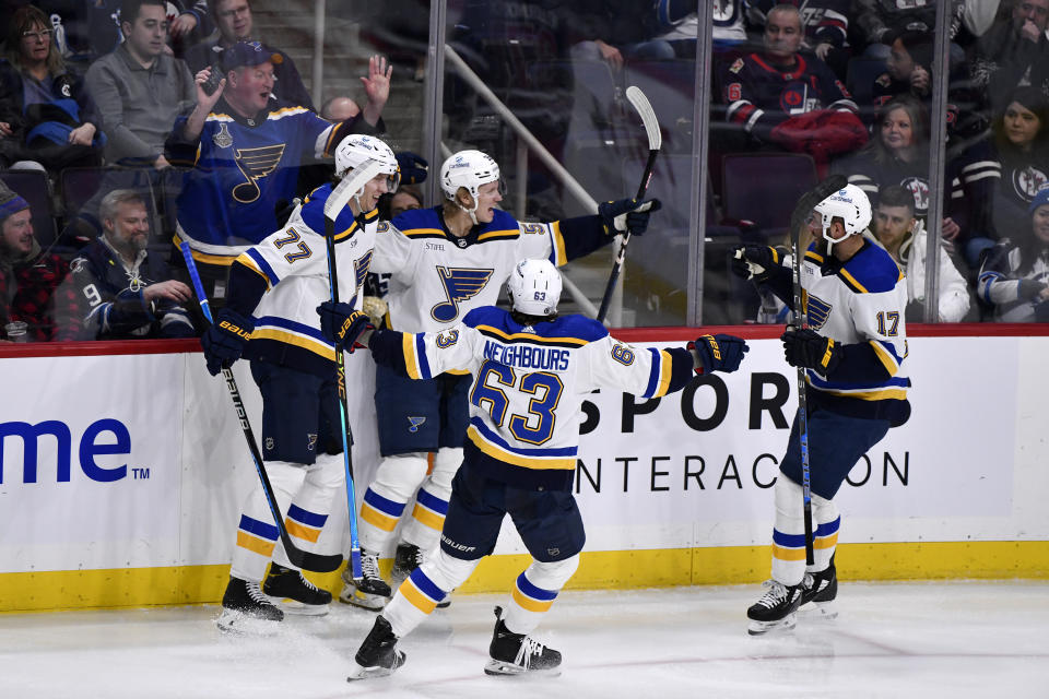 St. Louis Blues' Nikita Alexandrov (59) celebrates after his goal against the Winnipeg Jets with Niko Mikkola (77), Jake Neighbours (63) and Josh Leivo (17) during third-period NHL hockey game action in Winnipeg, Manitoba, Monday, Jan. 30, 2023. (Fred Greenslade/The Canadian Press via AP)