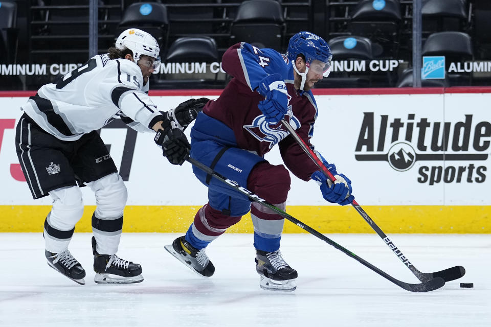 Colorado Avalanche defenseman Patrik Nemeth (24) moves the puck under pressure from Los Angeles Kings right wing Alex Iafallo (19) during the first period of an NHL hockey game Wednesday, May, 12, 2021, in Denver. (AP Photo/Jack Dempsey)