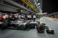 Mercedes driver Lewis Hamilton of Britain pulls out of his garage during the second practice session at the Marina Bay City Circuit ahead of the Singapore Formula One Grand Prix in Singapore, Friday, Sept. 20, 2019. (AP Photo/Vincent Thian)