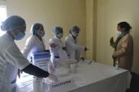 Nurse Shimray Wungreichon, 43, speaks to colleagues who will administer her the COVID-19 vaccine at the District Hospital in Ukhrul, in the northeastern Indian state of Manipur, Saturday, Jan. 16, 2021. Wungreichon was among the first of many Indian health workers to be vaccinated on Saturday, opening a new chapter in the battle against the pandemic in the world's second hardest-hit country, which has been scarred profoundly by a virus that has killed more than 152,000 of its people. (AP Photo/Yirmiyan Arthur)