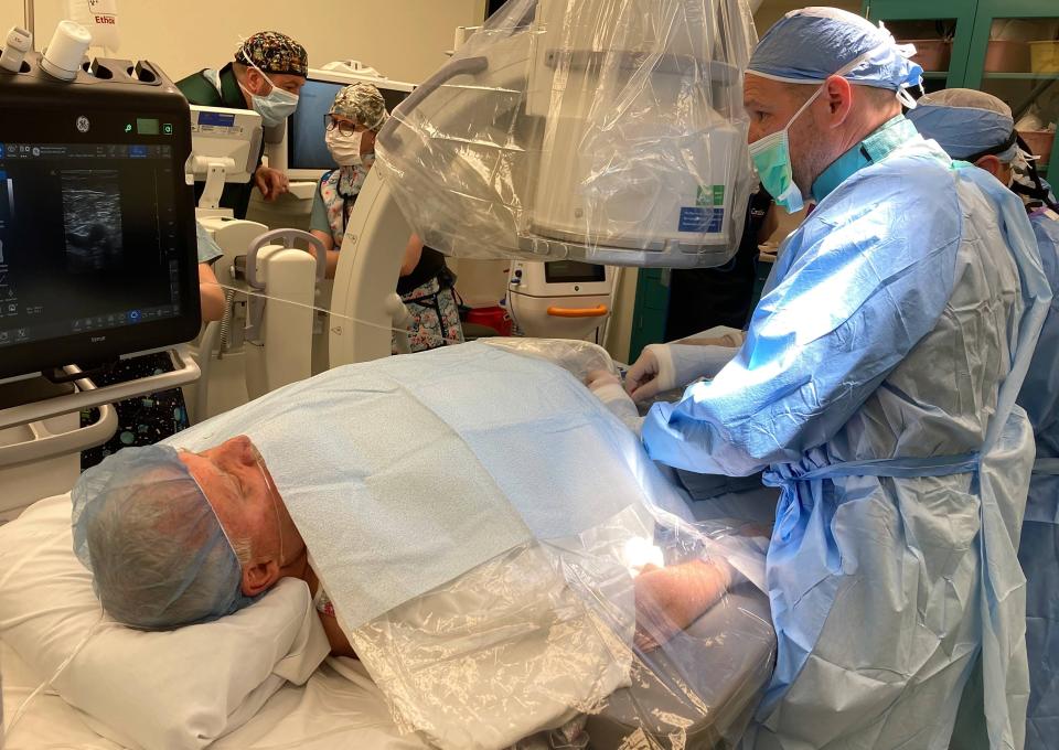 Dr. Matthew "Casey" Becker, a LECOM Health cardiologist, begins a new renal denervation procedure April 25 on patient Steven Davis, 73, at Millcreek Community Hospital.