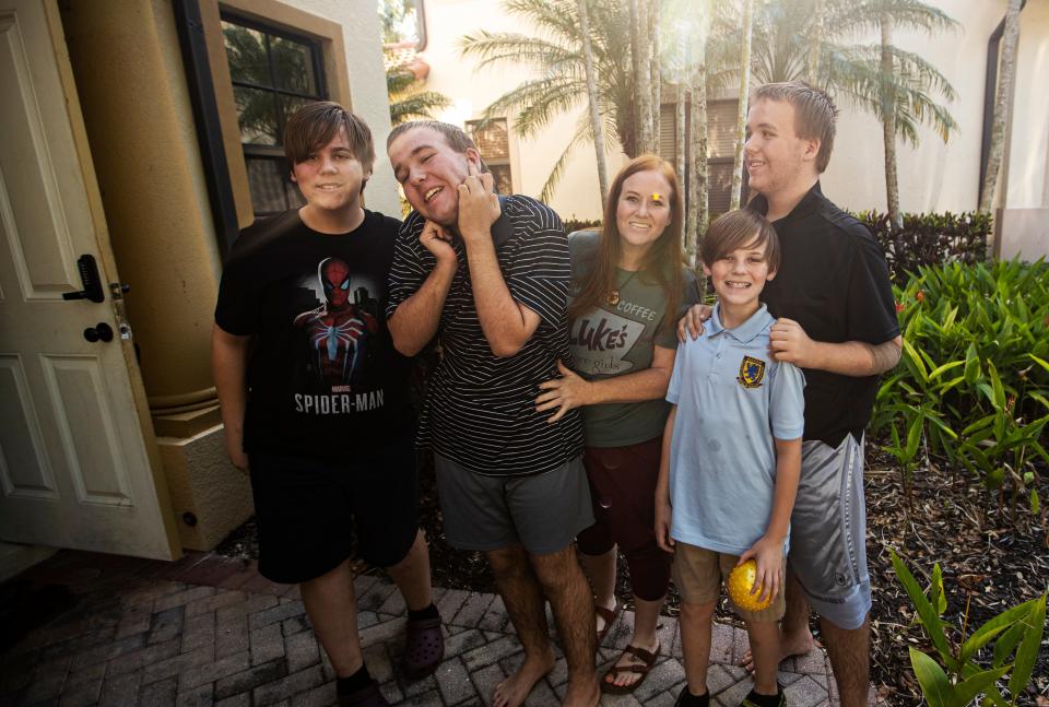 Stephanie Nordin, center, stands for a portrait with her sons from left, Eli, Gavin, Titus and Logan at their Naples home on Monday, April 15, 2024. Her twins, Gavin and Logan, 14, have autism. She has become successful at champion-ing some legislation for the state to protect children with autism.