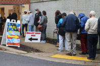 FILE - In this Monday, Oct. 26, 2020, file photo, voters wait in line to enter the Pip Moyer Recreation Center, in Annapolis, Md., on the first day of in-person early voting in the state. Tens of millions of Americans already cast ballots in the 2020 election amid record-breaking early voting during the coronavirus pandemic. But for some voters in a handful of states, casting an early ballot in-person isn't even an option. (AP Photo/Brian Witte, File)