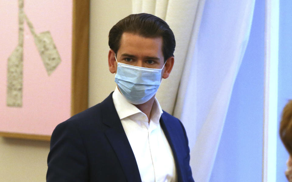 Austrian Chancellor Sebastian Kurz with a face mask walks at the federal chancellery in Vienna, Austria, Saturday, Oct. 31, 2020. The Austrian government has moved to restrict freedom of movement for people, in an effort to slow the onset of the COVID-19 coronavirus. (AP Photo/Ronald Zak)