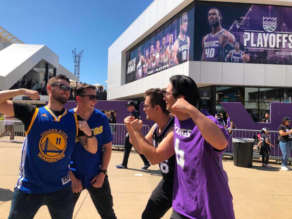 Golden State Warriors fans Jared Rose, 24, left, and Blake Landis, 24, both from the Bay Area, pretend to face off with Sacramento Kings fans Daniel Shevchyk, 24, and John “JC” Dossantos, 23, both East Sacramento residents, at Downtown Commons before their teams meet in the first game of their NBA playoff series on Saturday.