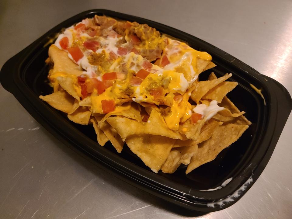 container of nacho bellgrande chips with toppings from taco bell