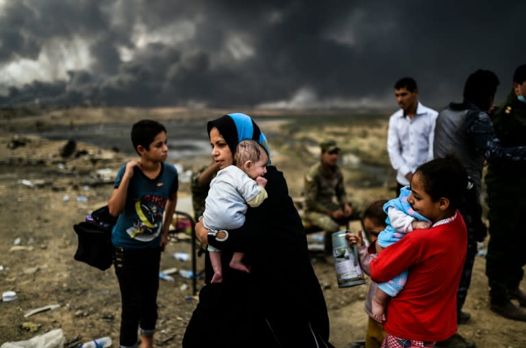 Iraqi families, displaced by the ongoing operation against the Islamic State to retake the northern city of Mosul, pictured near Qayyarah on October 24, 2016