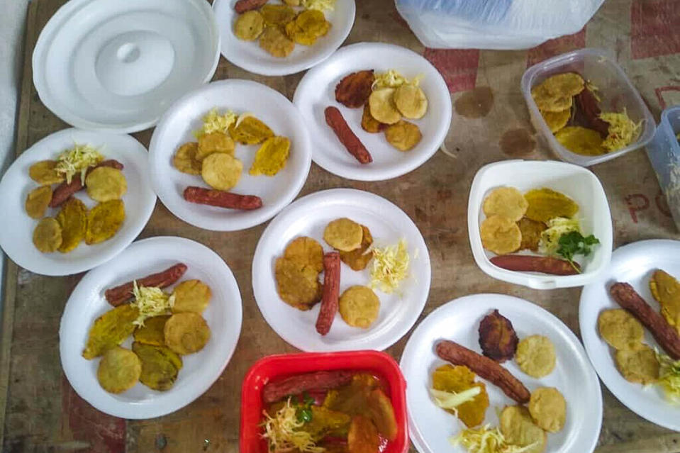 Styrofoam plates of plantains and hotdogs (Courtesy Telemaque Vernet)
