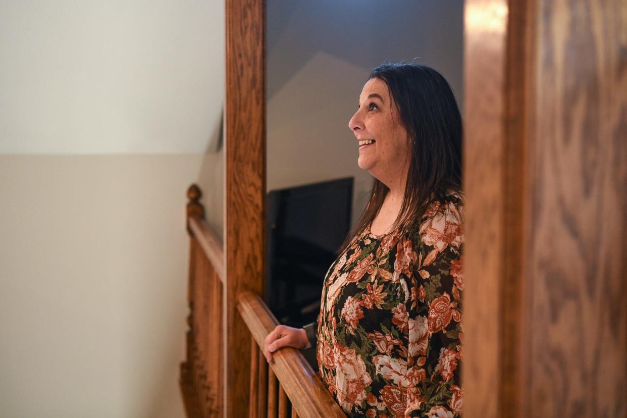 Brooke Rogers, a graduate of Hand UP For Women, looks around the nonprofit's new home and smiles, Friday, Feb. 2, 2024. She says that Hand UP For Women saved her life, and today, Brooke celebrates 14 years of sobriety and says, "this became my support and my family."