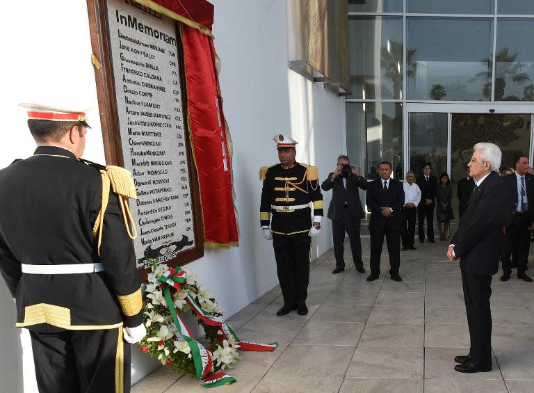 Italian President Sergio Mattarella (R) lays a wreath at a monument displaying the names of those killed by gunmen in the Bardo Museum attack, during his visit to Tunis on May 18, 2015