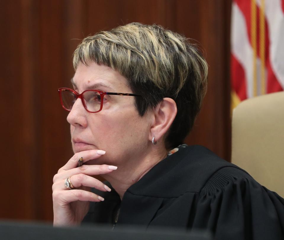 Summit County Common Pleas Judge Tammy O'Brien listens to William Huston's statement before sentencing him for involuntary manslaughter in the death of his 6-year-old son, Logan.