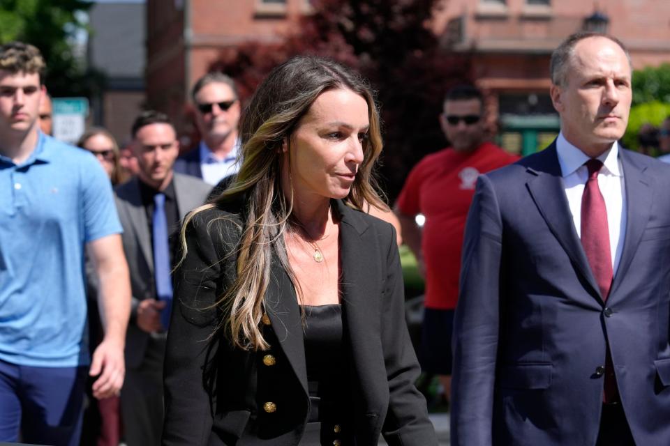 Karen Read, center, arrives at Norfolk Superior Court, while walking near defense attorney David Yannetti, right, Thursday, June 27, 2024, in Dedham, Mass. Read is on trial, accused of killing her boyfriend Boston police Officer John O'Keefe, in 2022. The jury began deliberations in the trial Tuesday. (AP Photo/Steven Senne)