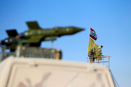 FILE PHOTO: A Hezbollah fighter stands at a watch tower at Juroud Arsal, the Syria-Lebanon border, July 29, 2017. REUTERS/Ali Hashisho/File Photo