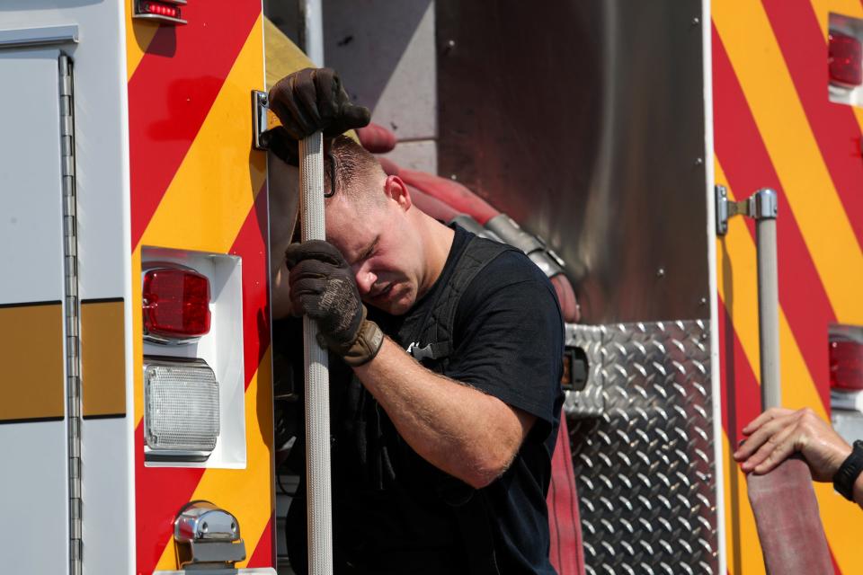 Palm Springs Fire Department probationary firefighter Hayden Wright is overcome by the heat following a training amid triple-digit temperatures in Palm Springs, Calif., on July 17, 2024. Firefighters train for preparedness as well as for heat tolerance.