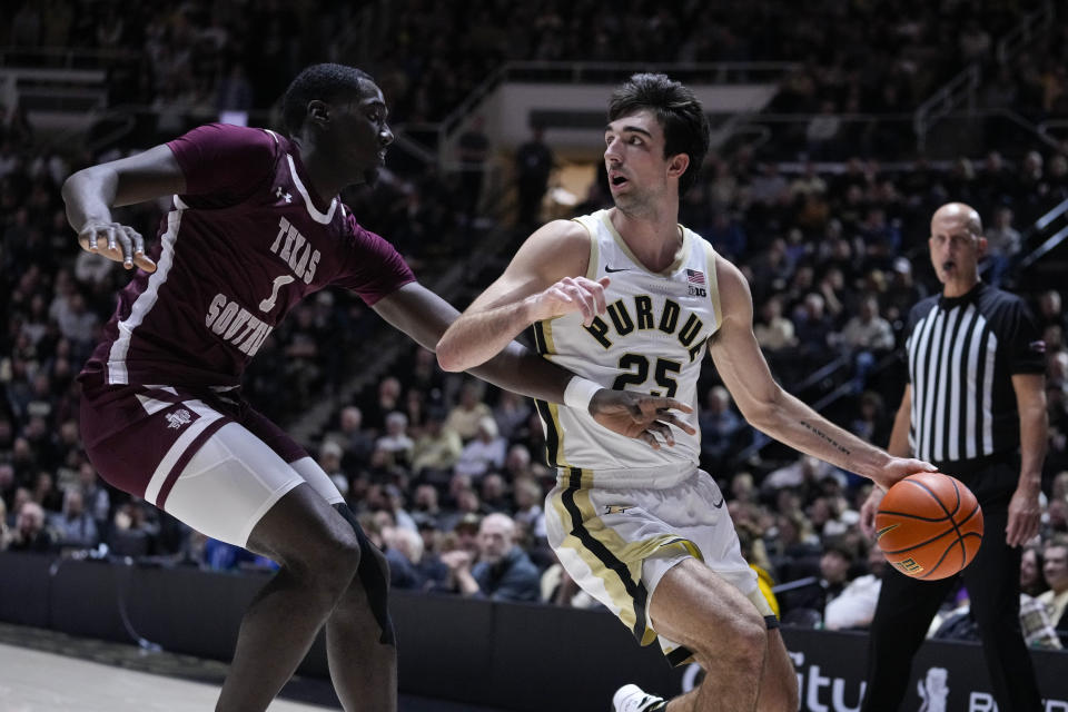 Texas Southern forward Kenny Hunter (1) defends Purdue guard Ethan Morton (25) during the second half of an NCAA college basketball game in West Lafayette, Ind., Tuesday, Nov. 28, 2023. (AP Photo/Michael Conroy)