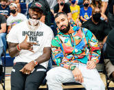 <p>LeBron James and Drake watch James' son Bronny's game as Sierra Canyon takes on Corona Centennial during the CIF Southern Sectional Basketball Finals on June 11 in L.A. </p>