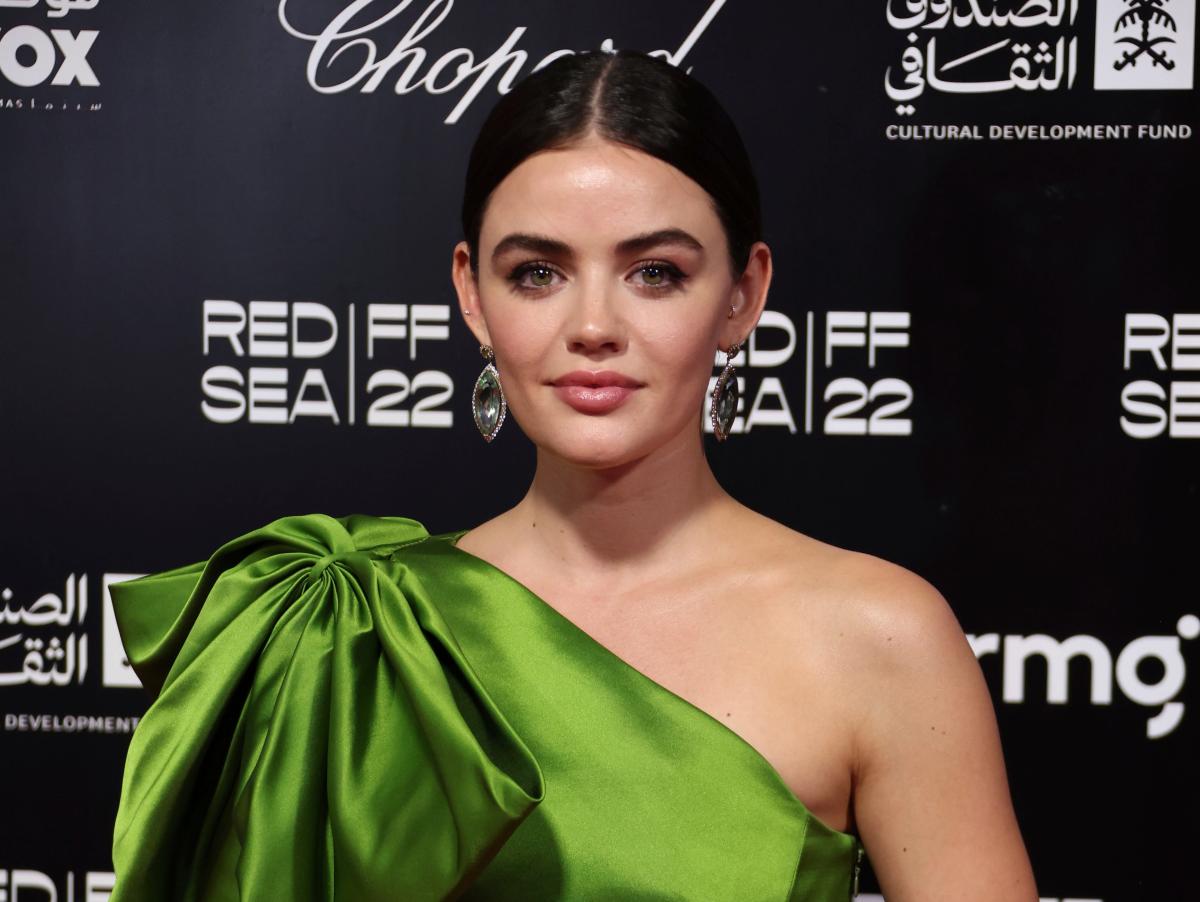 Lucy Hale is undeterred by heavy rainfall as she makes her way to