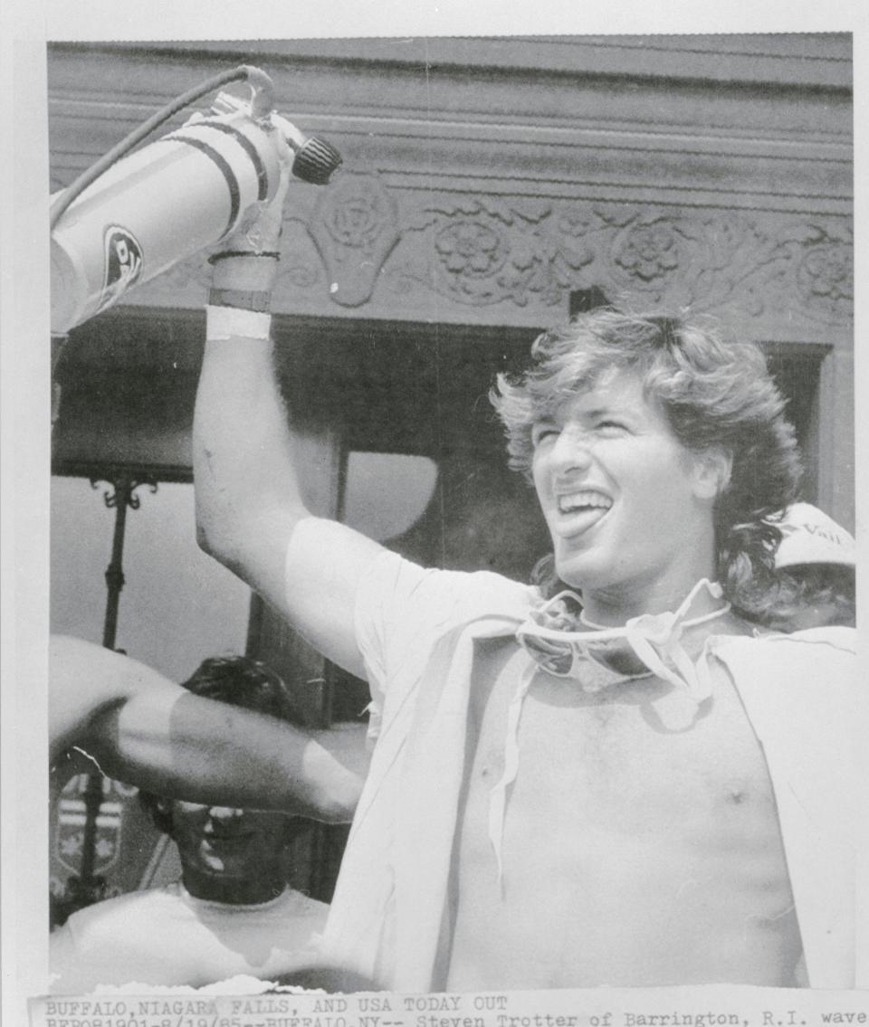 Steven Trotter of Rhode Island waves one of the oxygen bottles he took with him over Niagara Falls in a barrel in 1985.