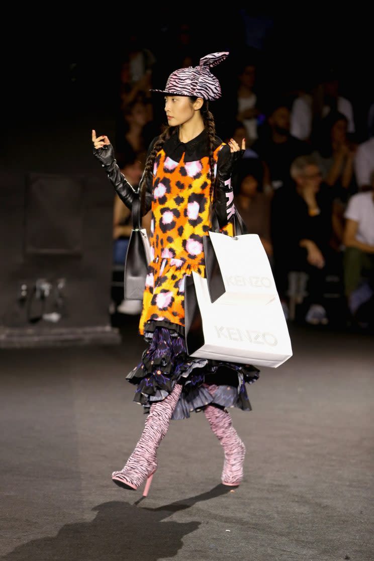 A model walks in the show carrying the Kenzo x H&M “shopping bags.” (Photo: Courtesy of H&M)