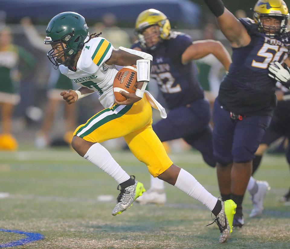 Firestone quarterback Daylyn Taylor runs for a third-quarter touchdown against Copley on Friday in Copley.