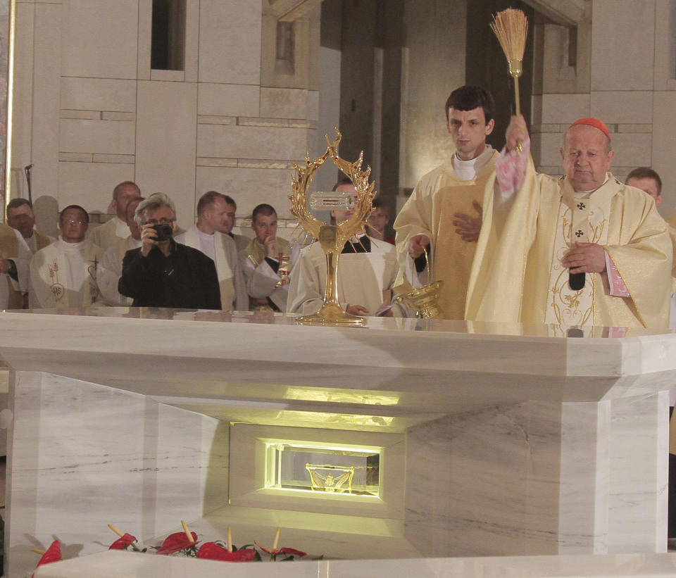 FILE - In this June 11, 2011 file photo Cardinal Stanislaw Dziwisz, right, consecrates the reliquary containing a drop of blood of the late Pope John Paul II in the Lagiewniki John Paul II Sanctuary in Krakow, Poland. The sanctuary consists of a new church and pilgrim center and is the brainchild of John Paul’s personal secretary, Cardinal Stanislaw Dziwisz, who is now the city’s archbishop. (AP Photo)